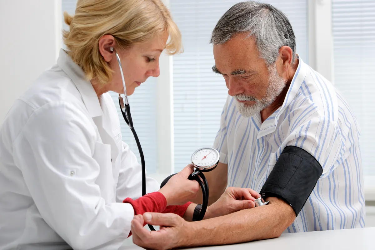 Doctor checking a patient's heartbeat with a stethoscope