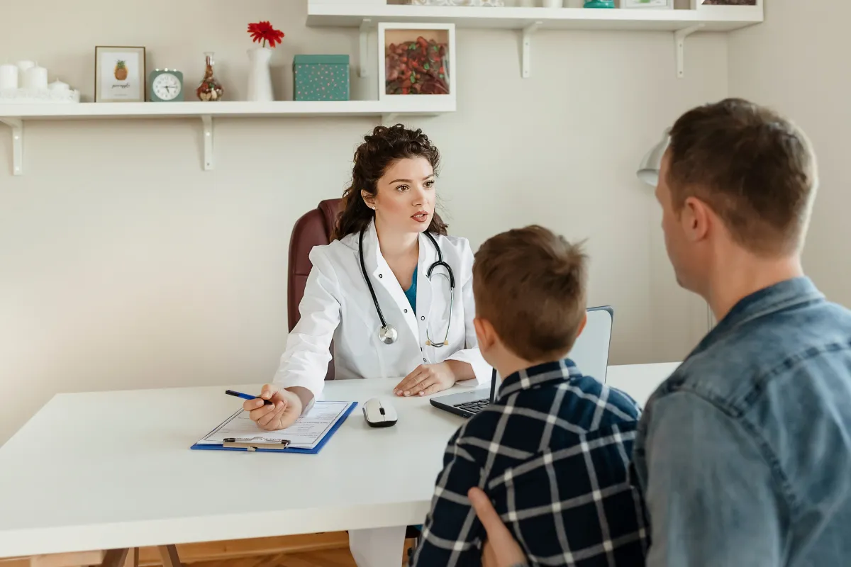 A happy child receiving a checkup from a friendly pediatrician
