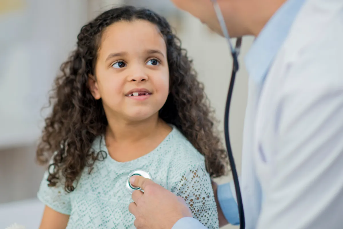Doctor checking a child's heartbeat with a stethoscope