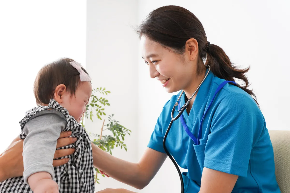 Doctor giving a child a vaccination in a friendly setting