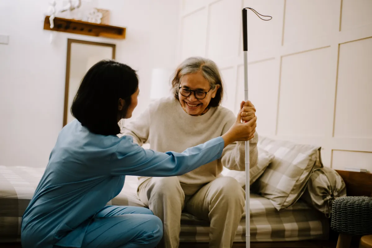 A smiling senior woman with a caregiver.